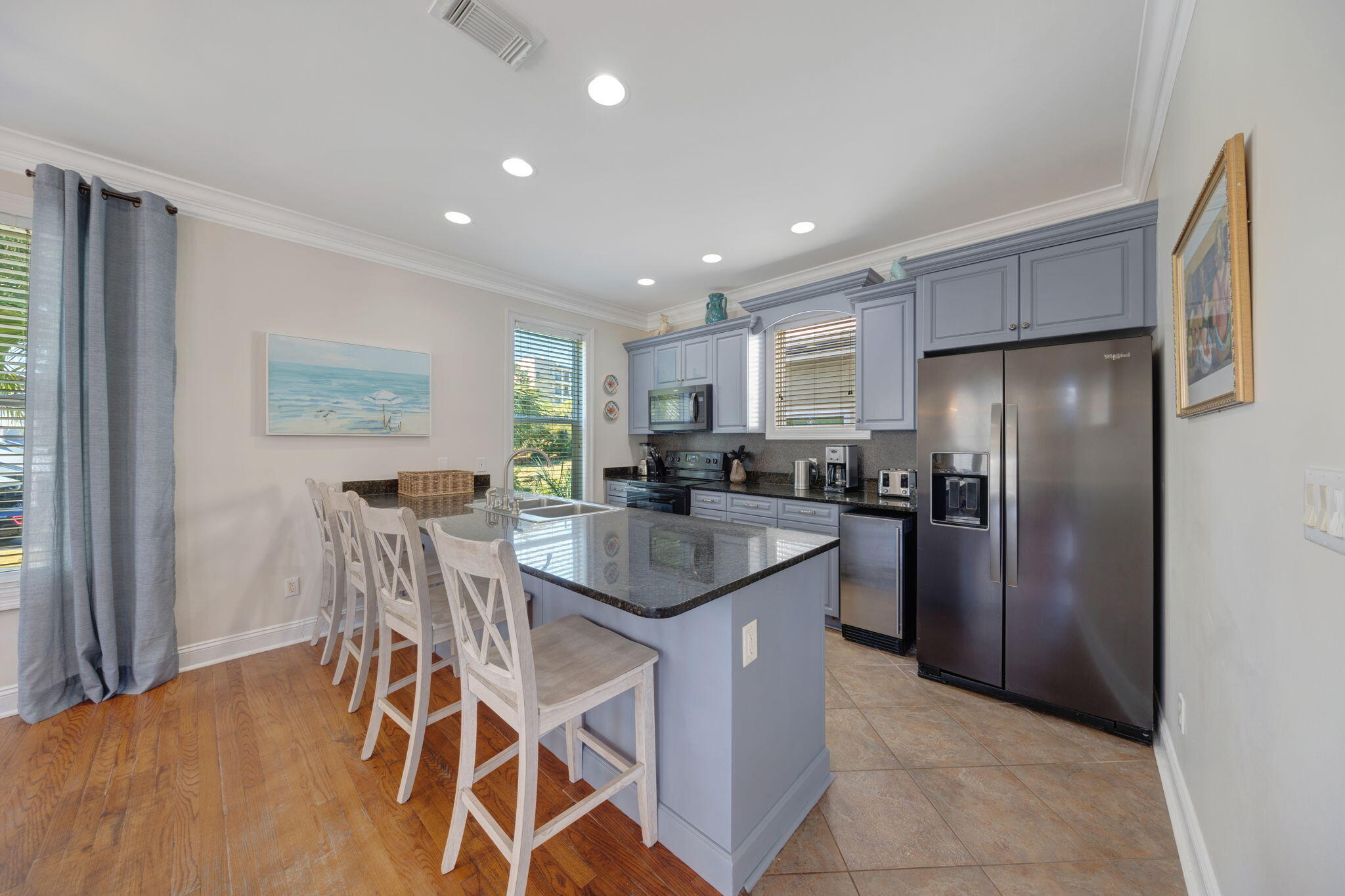 44 South Grande Beach Drive Santa Rosa Beach, FL 32459 - Photo 18 of 68 a kitchen with stainless steel appliances granite countertop a refrigerator a sink a stove and a dining table with wooden floor