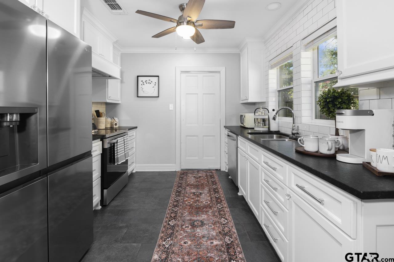 403 East Houston Street Tyler, TX 75701 - Photo 12 of 44 a kitchen with granite countertop stainless steel appliances a sink stove top oven and cabinets