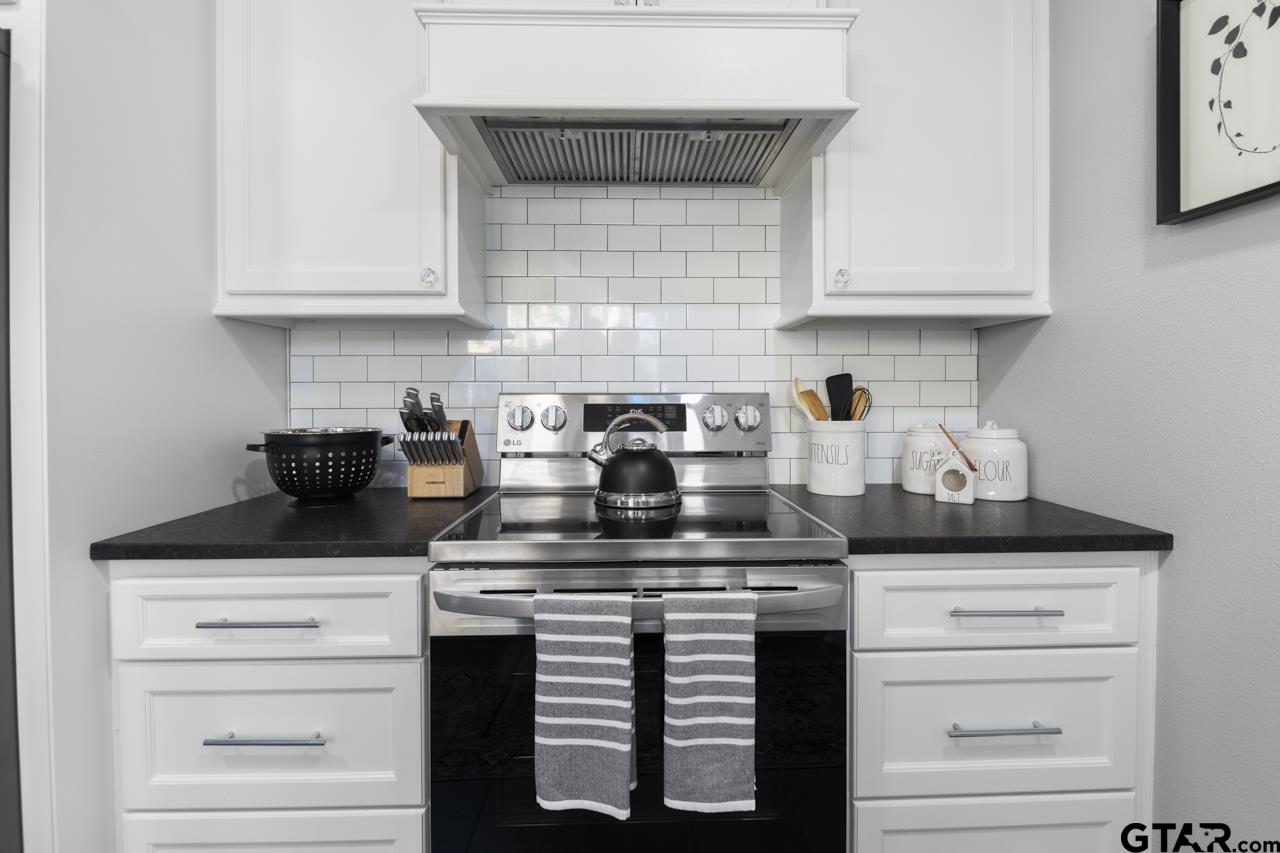 403 East Houston Street Tyler, TX 75701 - Photo 15 of 44 a kitchen with white cabinets and appliances