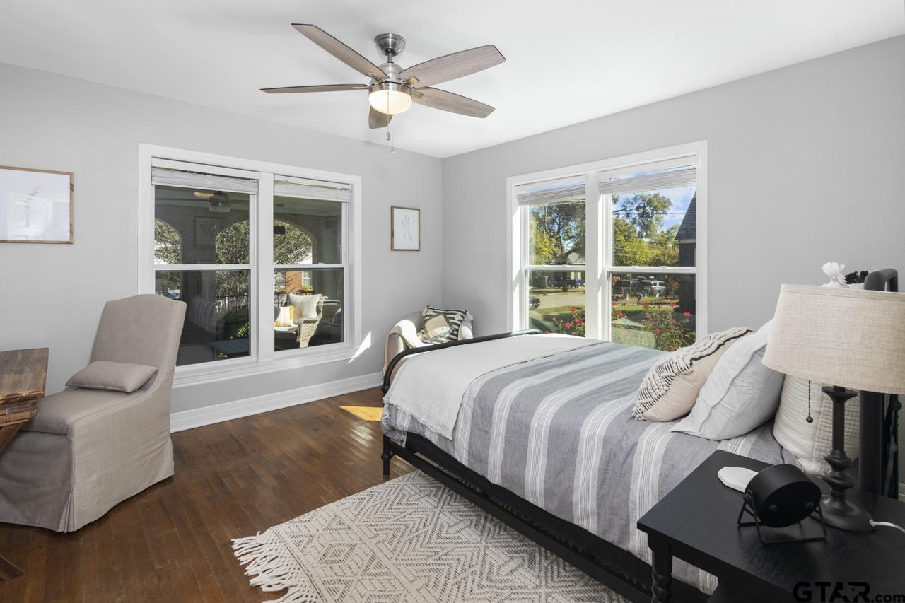 403 East Houston Street Tyler, TX 75701 - Photo 22 of 44 a bedroom with a bed and wooden floor