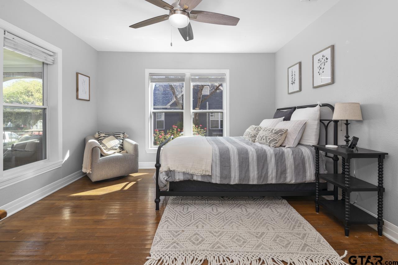 403 East Houston Street Tyler, TX 75701 - Photo 24 of 44 a bedroom with a bed and wooden floor