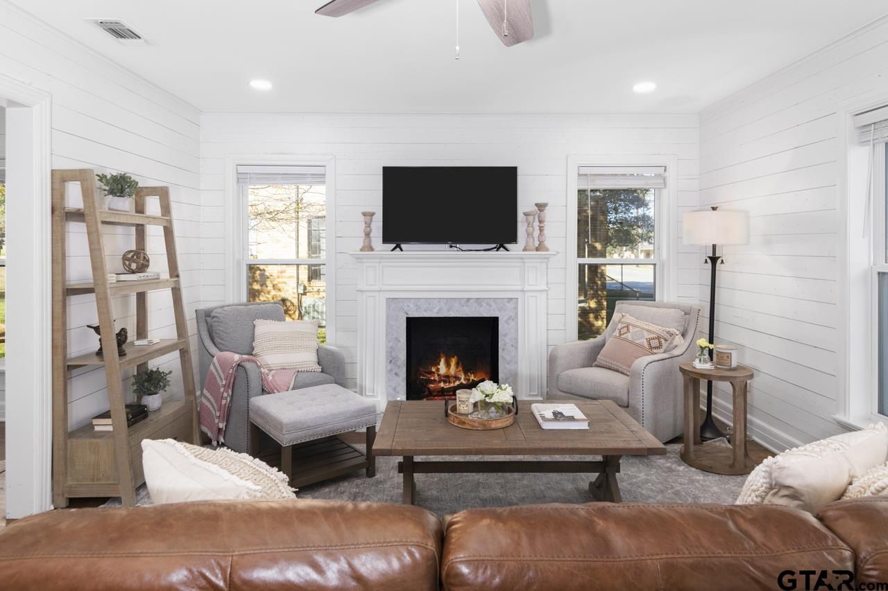 403 East Houston Street Tyler, TX 75701 - Photo 5 of 44 a living room with furniture a flat screen tv and a fireplace