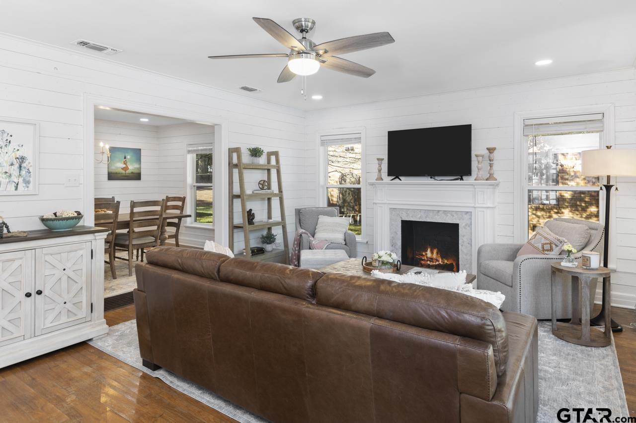 403 East Houston Street Tyler, TX 75701 - Photo 6 of 44 a living room with furniture a flat screen tv and a fireplace