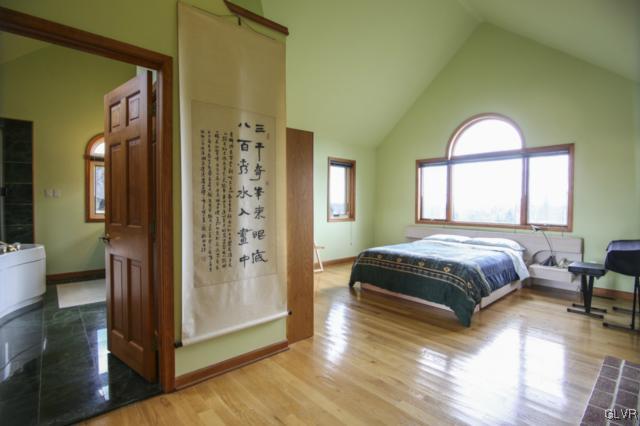 1205 Seifert Road Nazareth, PA 18064 - Photo 19 of 50 a spacious bedroom with a balcony a bed and a painting on the wall