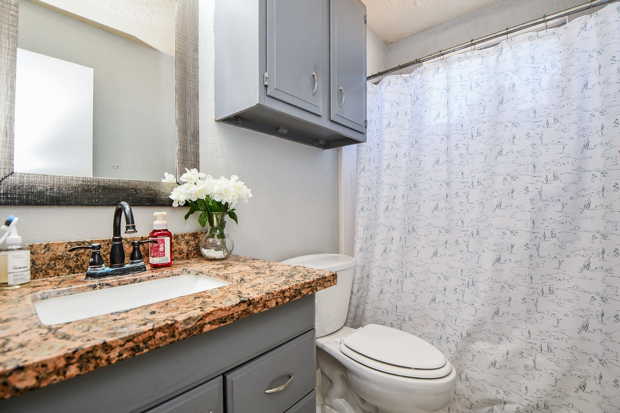 16711 Ribbonridge Drive Sugar Land, TX 77498 - Photo 19 of 24 a bathroom with a granite countertop sink a toilet and a mirror