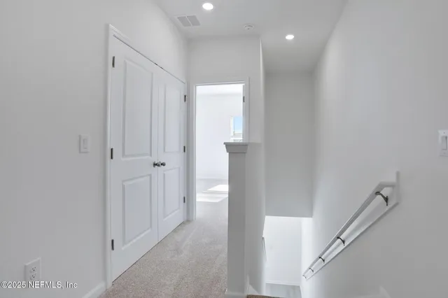 a view of a hallway with white walls