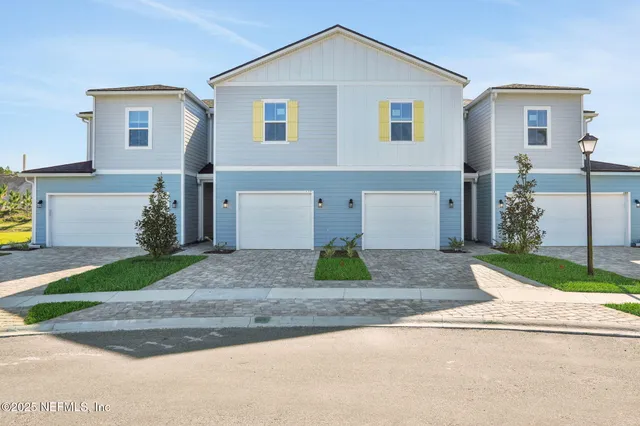a front view of a house with a yard and a garage