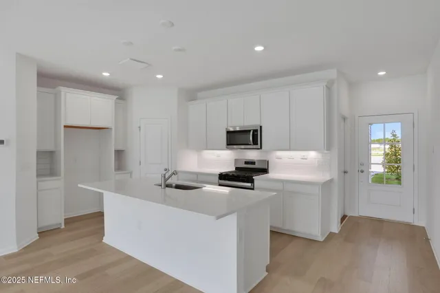 a kitchen that has a sink and a refrigerator