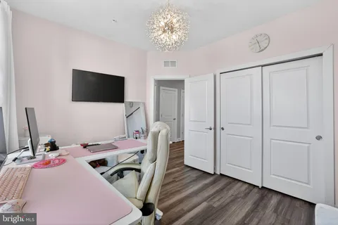 a view of a workspace with furniture and a flat screen tv