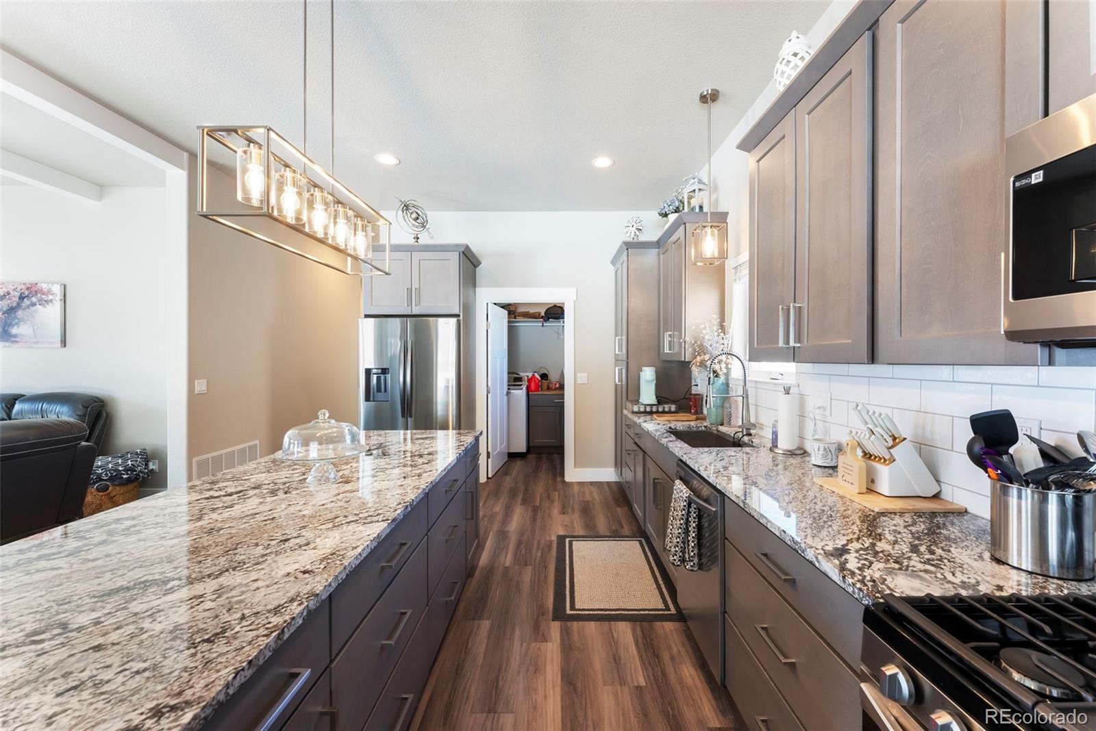 489 Duesouth Road Florissant, CO 80816 - Photo 12 of 40 a kitchen with granite countertop lots of counter top space a sink and stainless steel appliances