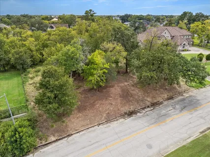 an aerial view of a houses with trees