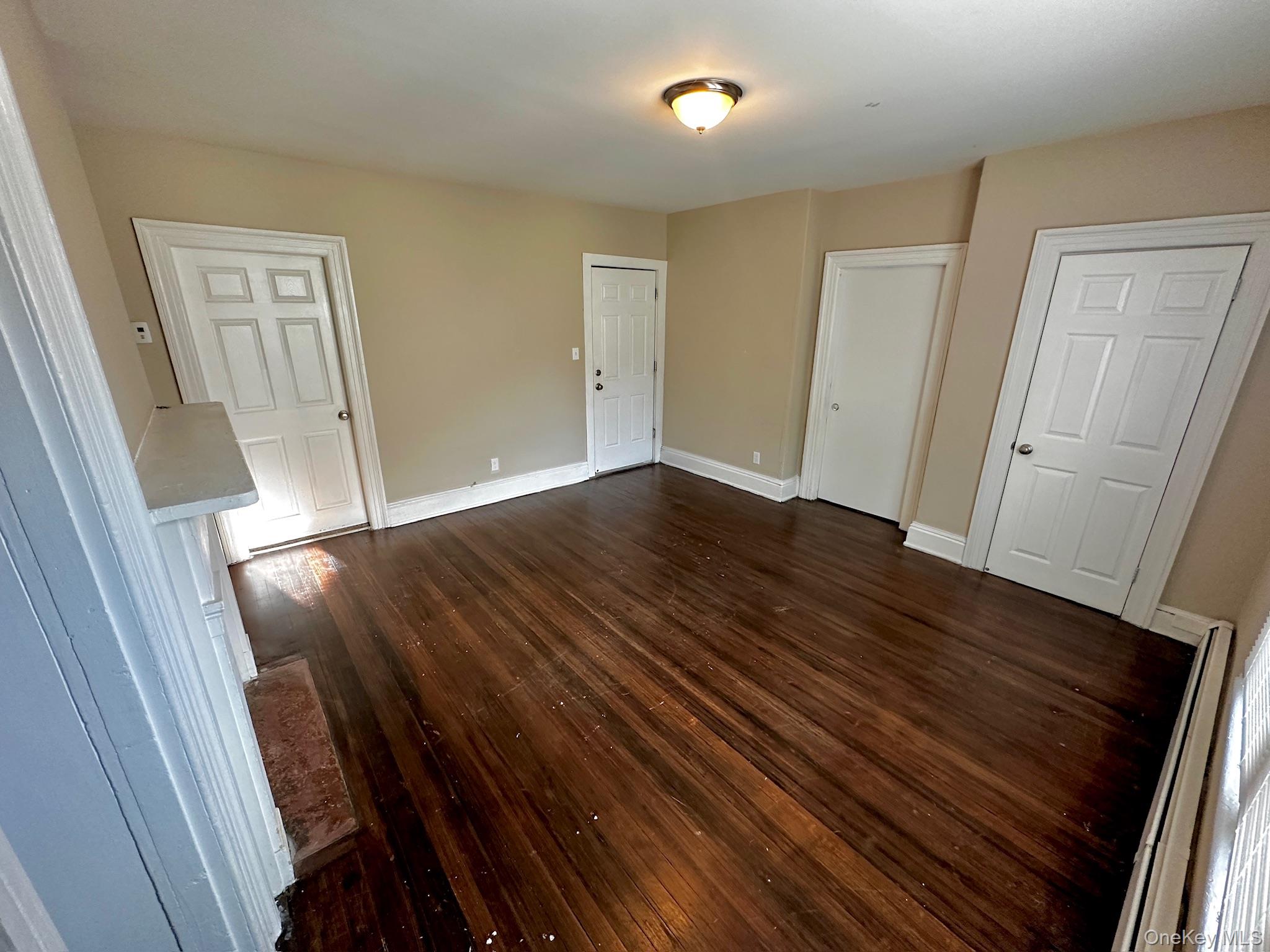 181 Mansion Street, Unit 2 Poughkeepsie, NY 12601 - Photo 17 of 20 Unfurnished bedroom featuring dark wood-style flooring and baseboards