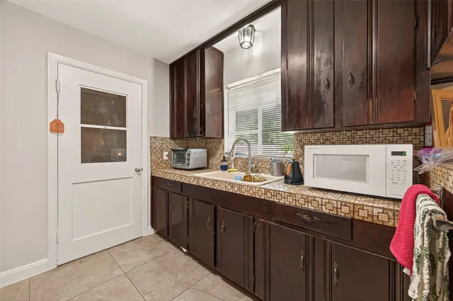 a white refrigerator freezer sitting inside of a kitchen