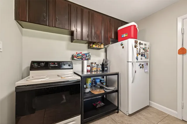 a kitchen with stainless steel appliances kitchen island granite countertop a sink stove and cabinets