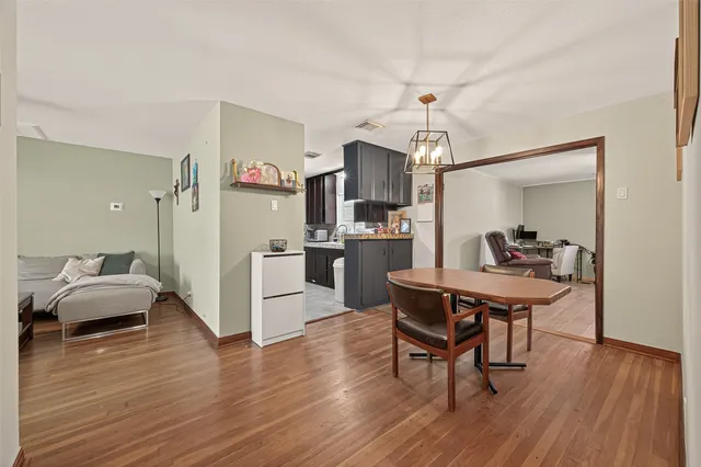 a kitchen with a dining table chairs and chandelier