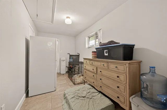 a kitchen with granite countertop cabinets stainless steel appliances a sink and a window
