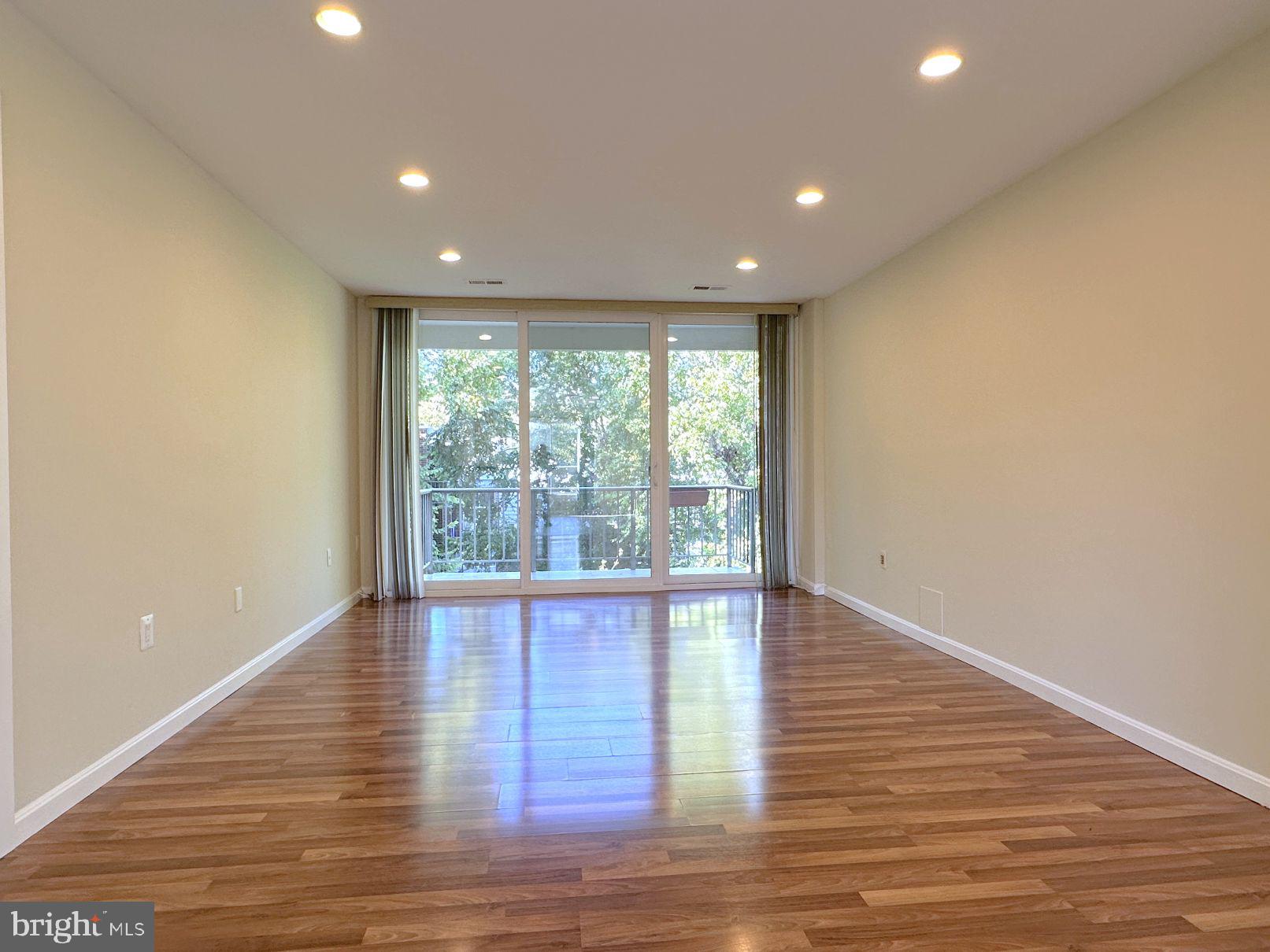 3940 Bel Pre Road, Unit 39408 Silver Spring, MD 20906 - Photo 12 of 24 Living room w/ slider to balcony