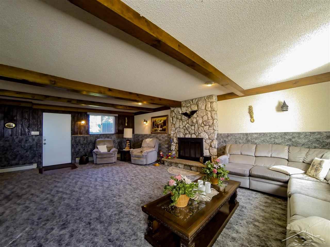 2366 West Wheeler Road Auburn, MI 48611 - Photo 5 of 15 Very large family room with plenty of character. Decorative beams on the ceiling, sound deadening on the walls, plenty of natural light, and an exterior door leading to the backyard. The Fireplace has