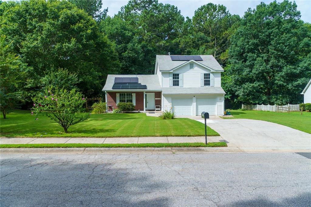 a front view of a house with a yard and garage