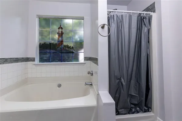 a bathroom with a bathtub and a shower