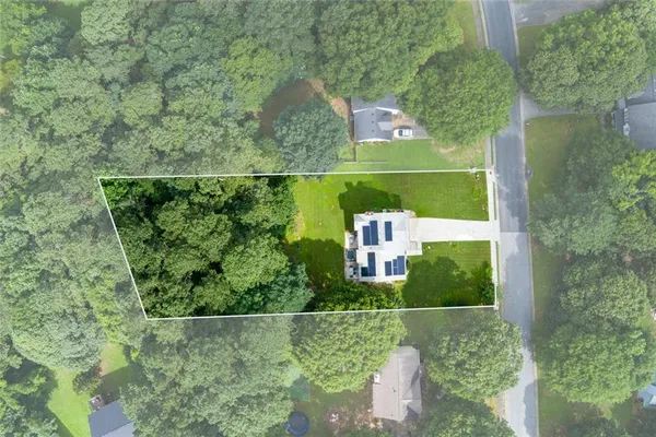 an aerial view of a house with a yard