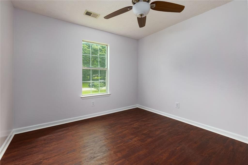 552 Casey's Crossing Winder, GA 30680 - Photo 10 of 26 a view of an empty room with wooden floor and a window