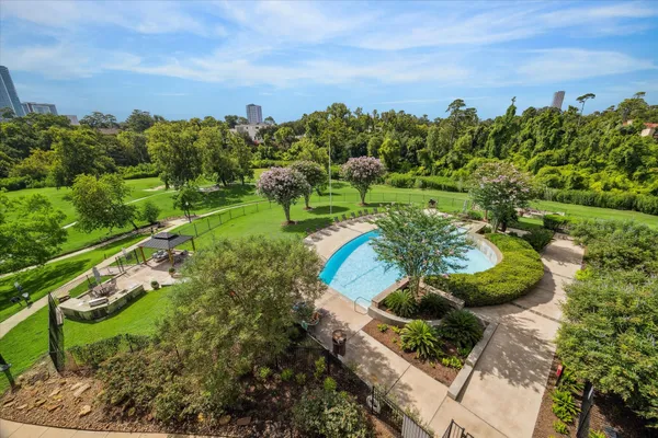 a view of a garden with a building in the background