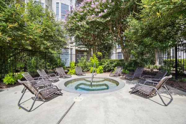 a swimming pool with outdoor seating and plants