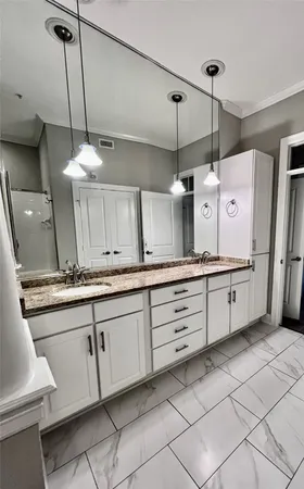 a kitchen with granite countertop white cabinets and white appliances