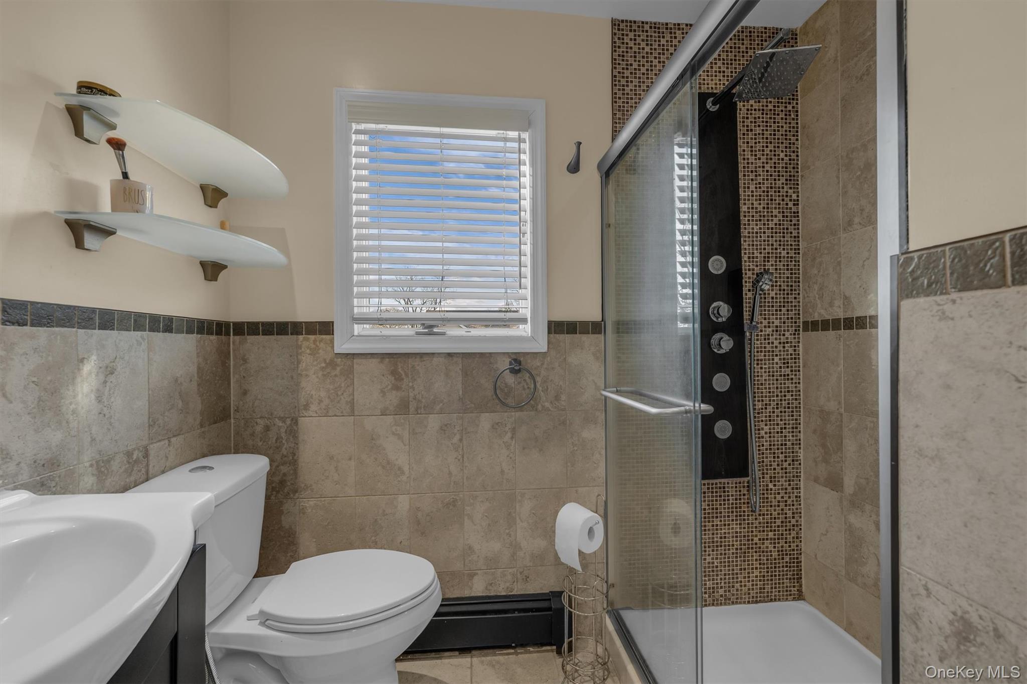 95 Liberty Boulevard Valley Stream, NY 11580 - Photo 11 of 17 a white toilet sitting next to a bathroom sink