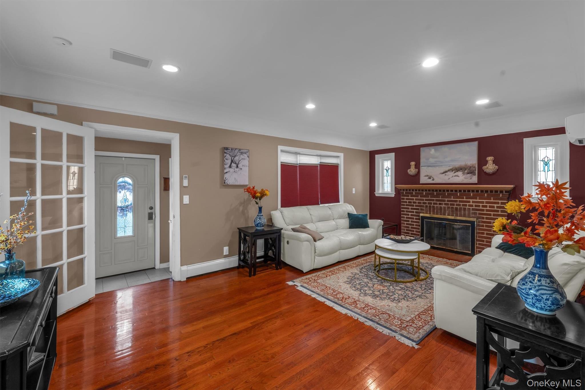 95 Liberty Boulevard Valley Stream, NY 11580 - Photo 3 of 17 a living room with furniture a fireplace and a flat screen tv