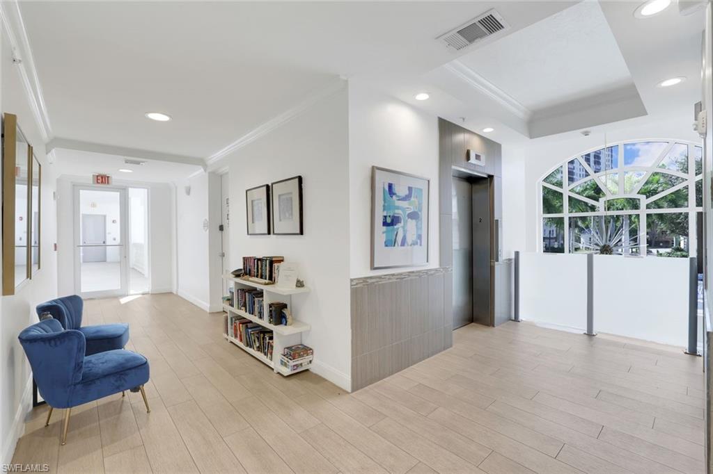 460 Launch Circle, Unit 202 Naples, FL 34108 - Photo 26 of 34 a living room with furniture and a large window