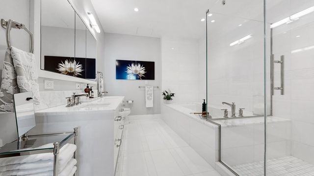 a bathroom with a double vanity sink a mirror and shower