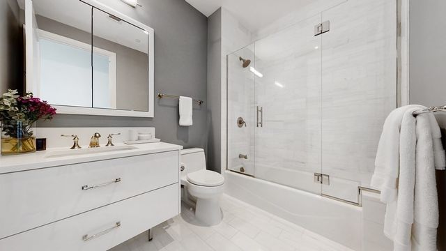 a bathroom with a sink toilet and shower
