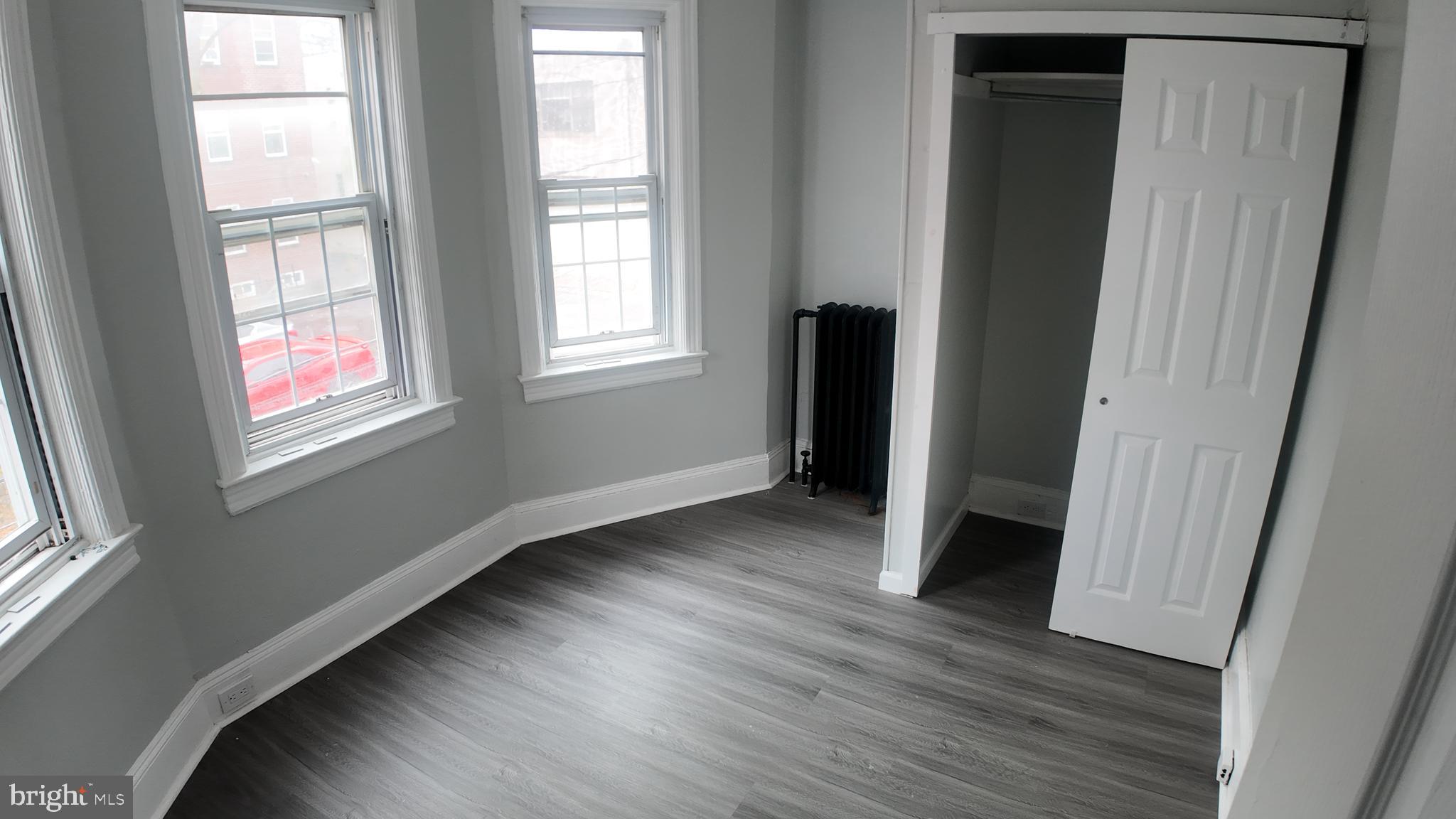 31 Maple Avenue Trenton, NJ 08618 - Photo 10 of 15 a view of an empty room with wooden floor and a window