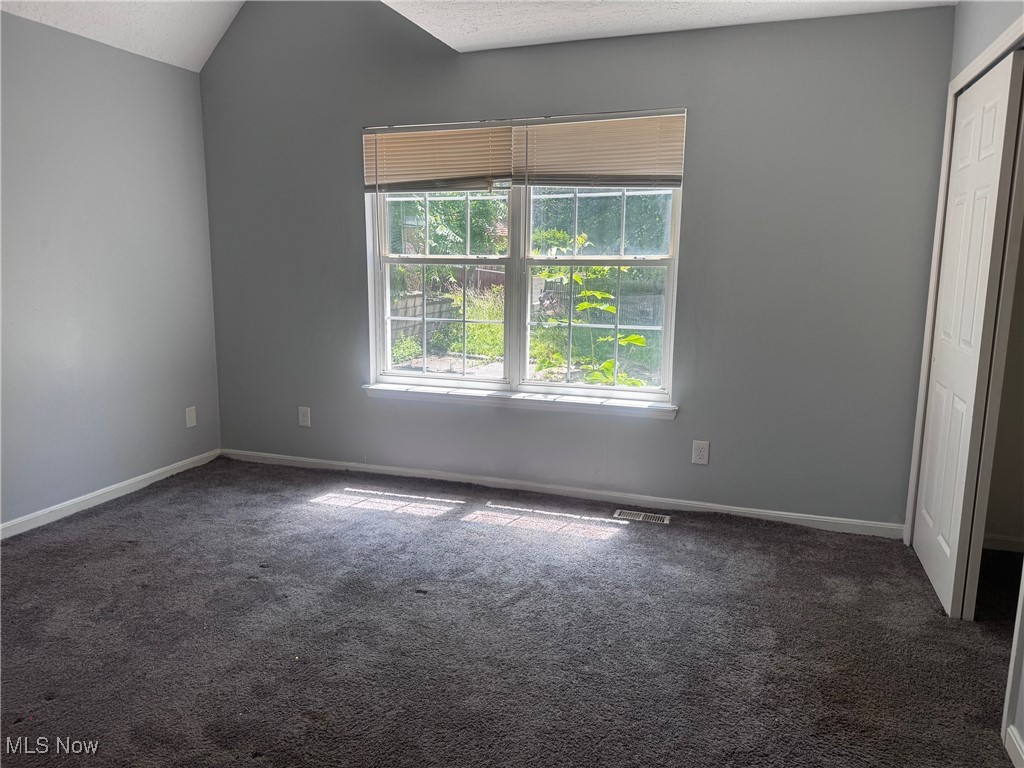 17714 South Miles Road Cleveland, OH 44128 - Photo 11 of 13 Unfurnished bedroom with carpet floors and a closet