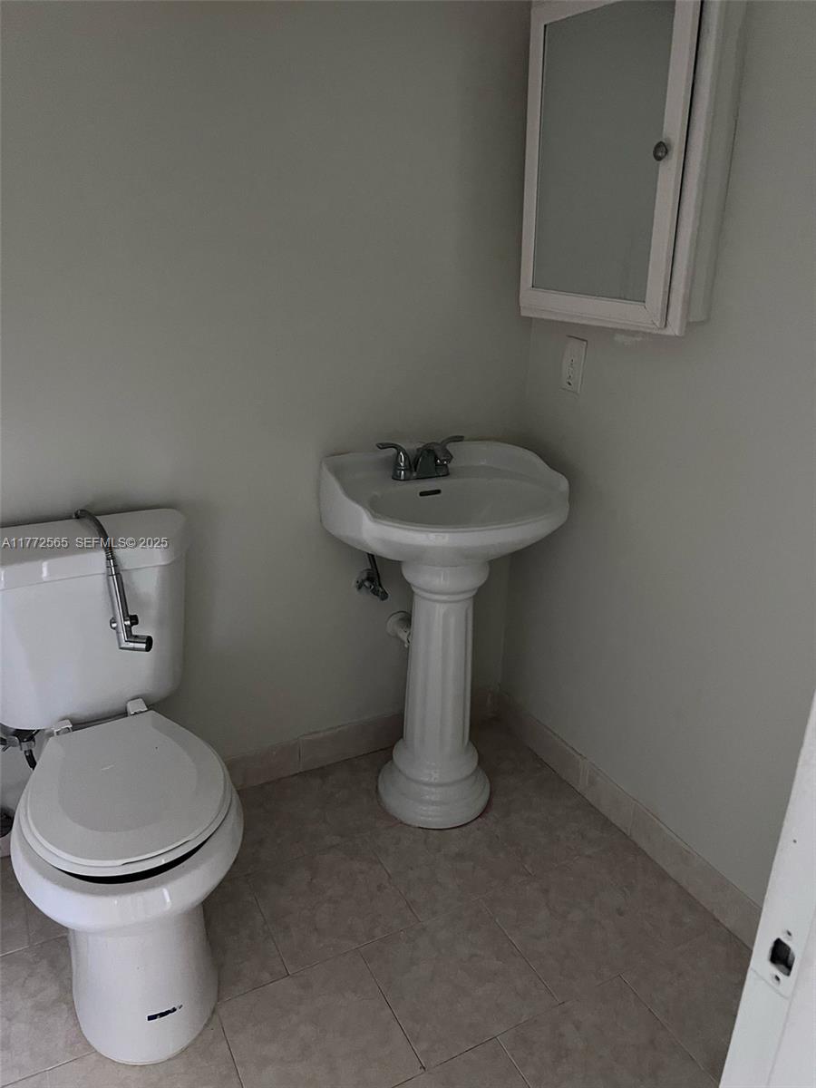 90 Fanshaw C, Unit 90 Boca Raton, FL 33434 - Photo 6 of 6 a bathroom with a sink toilet and a mirror
