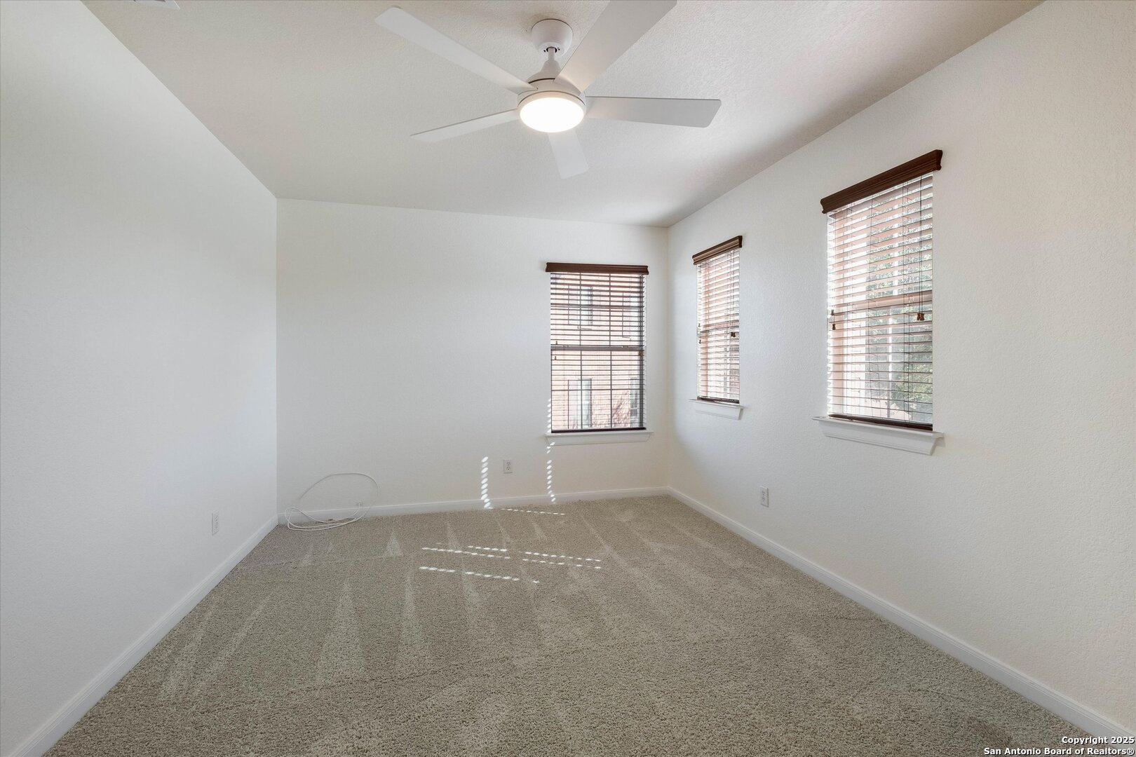 173 Springtree Gate Cibolo, TX 78108 - Photo 14 of 23 an empty room with windows and fan