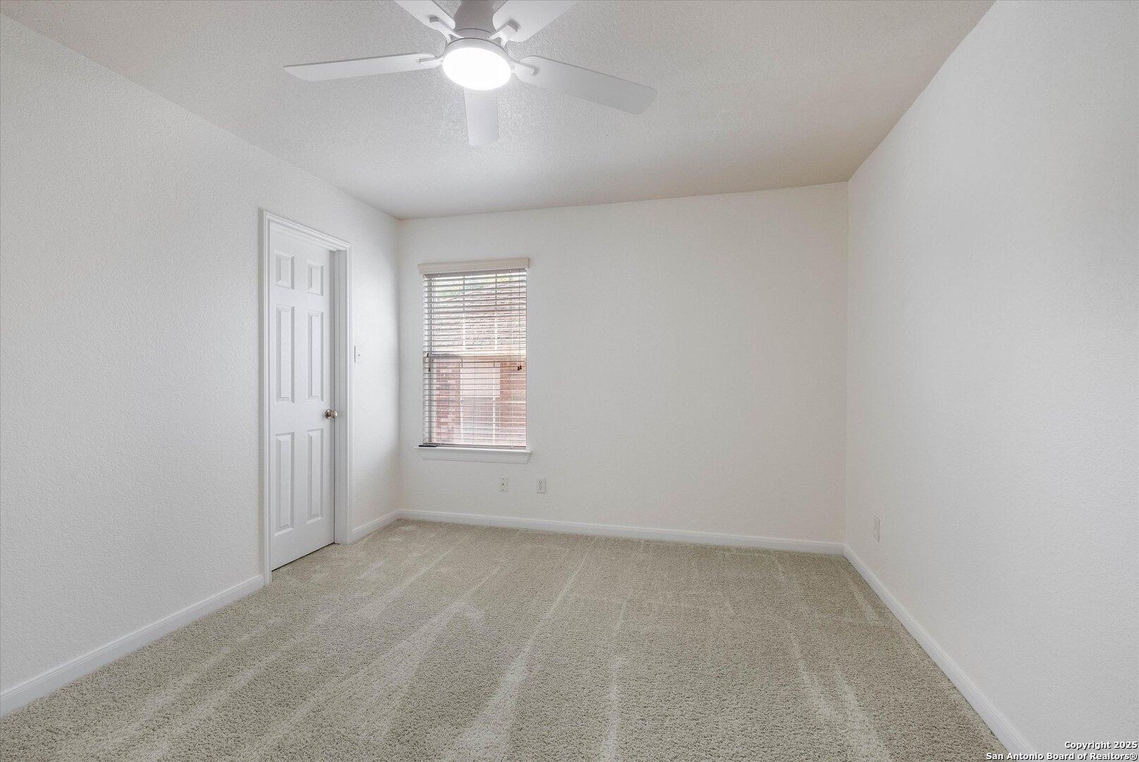 173 Springtree Gate Cibolo, TX 78108 - Photo 17 of 23 an empty room with a chandelier fan and windows