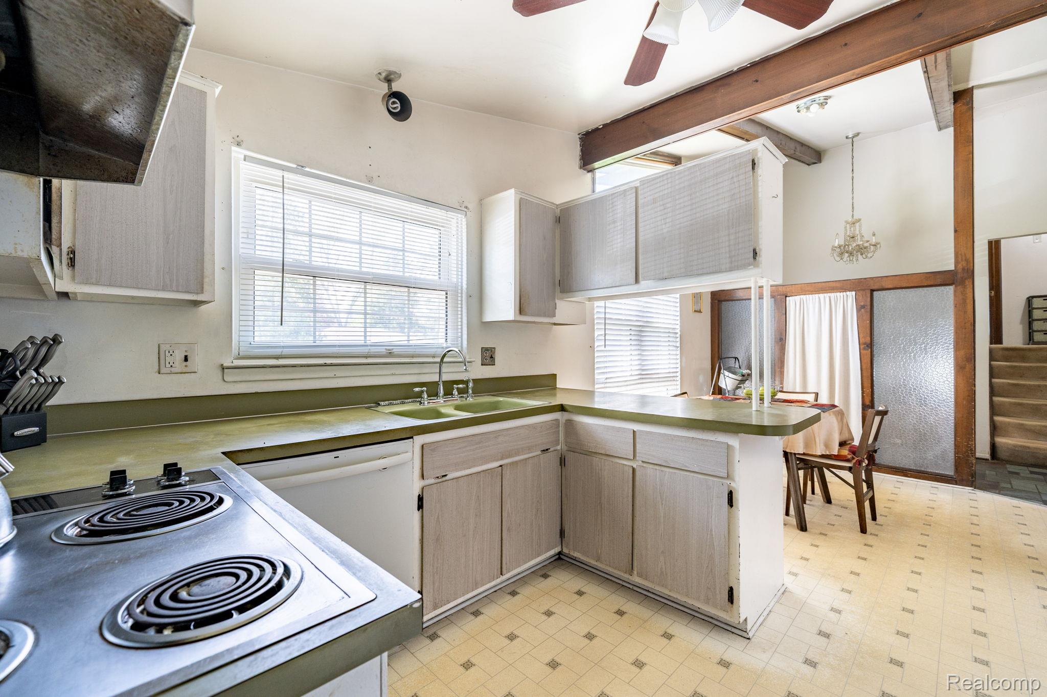 19650 Midway Road Southfield, MI 48075 - Photo 13 of 30 Kitchen with a peninsula, light floors, range hood, and electric stovetop