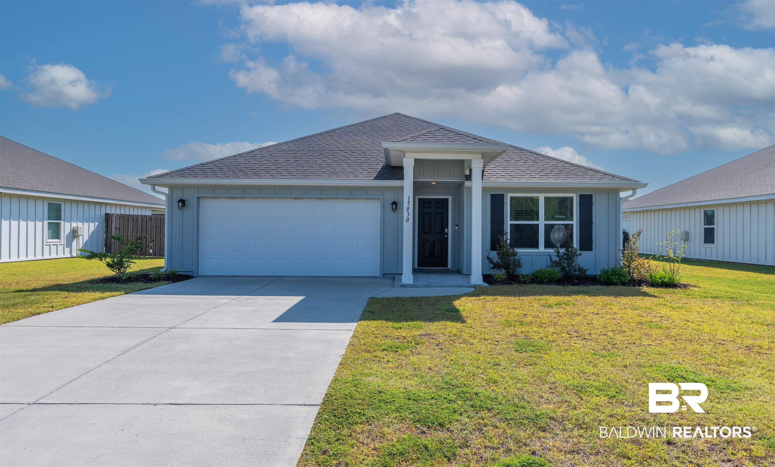 15030 Forsythia Loop Silverhill, AL 36576 - Photo 1 of 33 Single story home featuring a shingled roof, an attached garage, concrete driveway, and board and batten siding