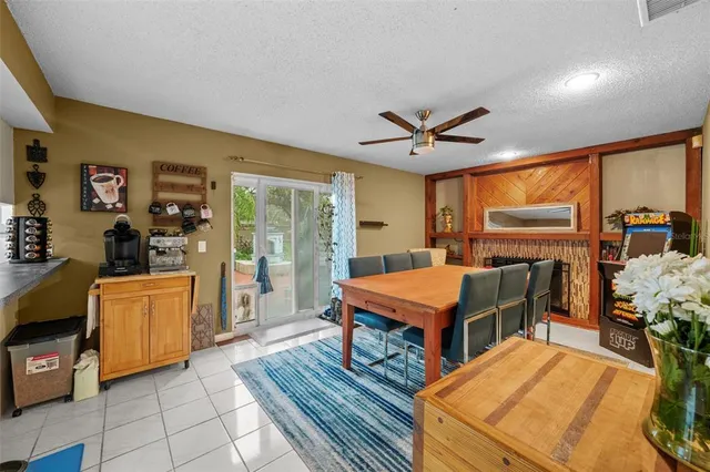 a living room with stainless steel appliances kitchen island granite countertop furniture and a fireplace