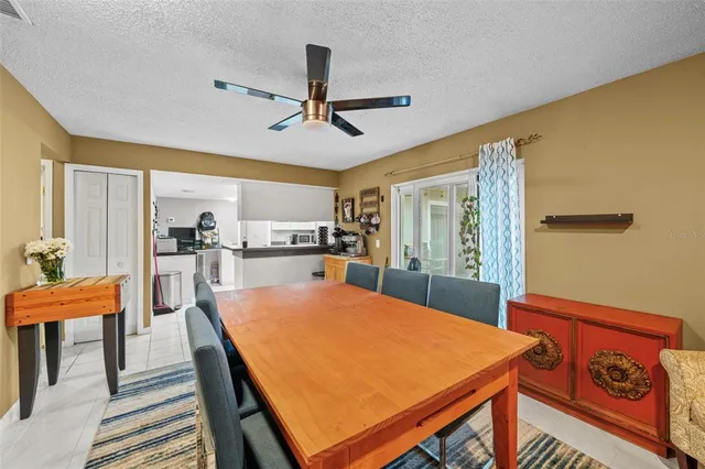 a room with stainless steel appliances kitchen island granite countertop furniture and a dining table