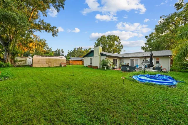 a view of an house with backyard space and porch