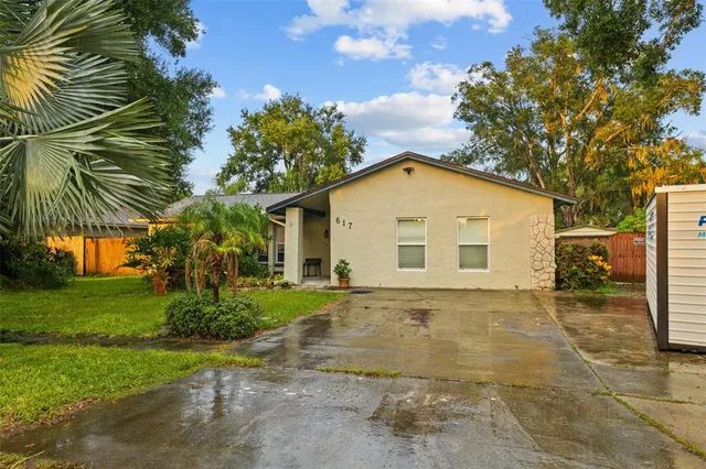 a view of backyard of house with green space