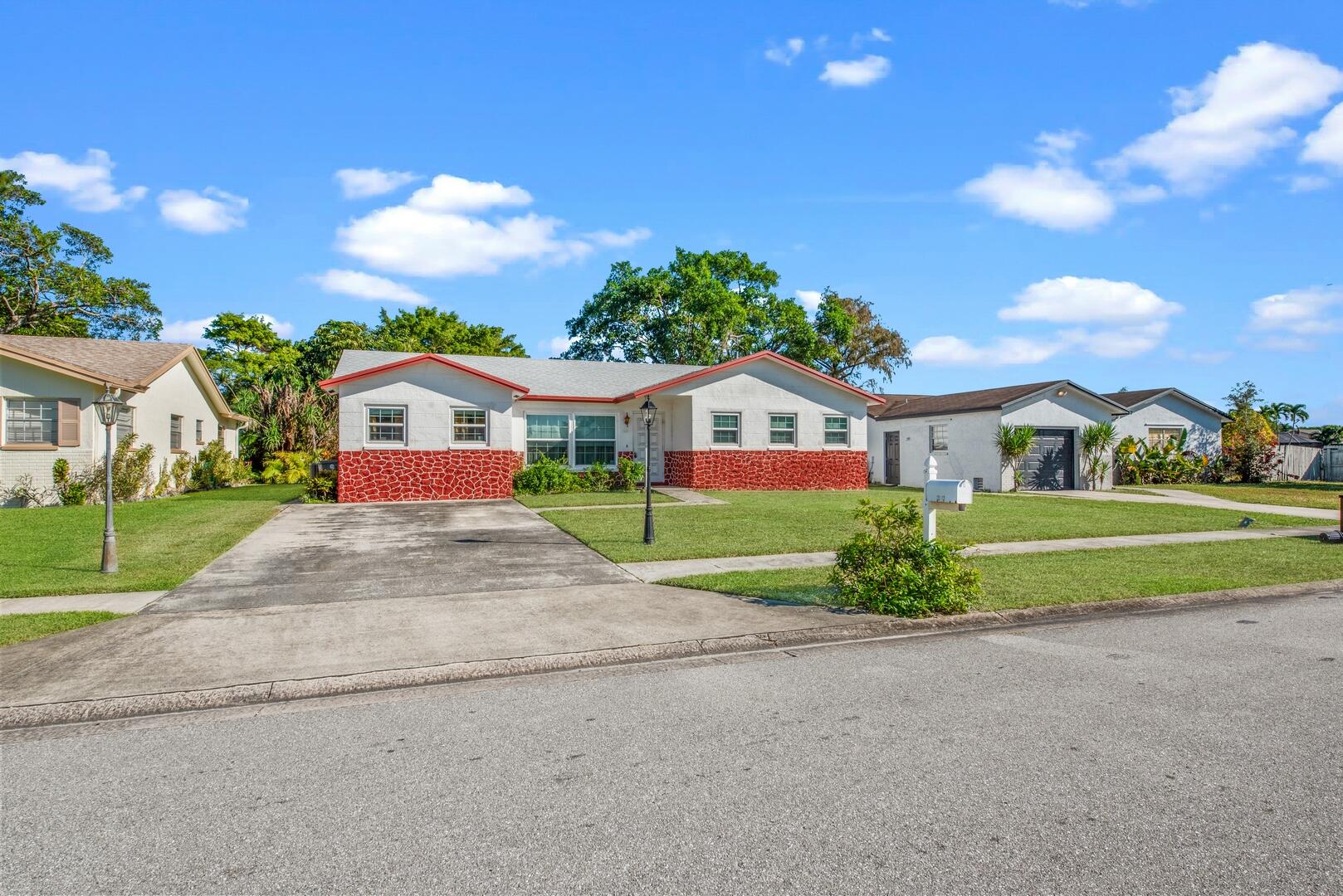 22602 Southwest 54th Way Boca Raton, FL 33433 - Photo 18 of 23 a front view of house with yard and green space