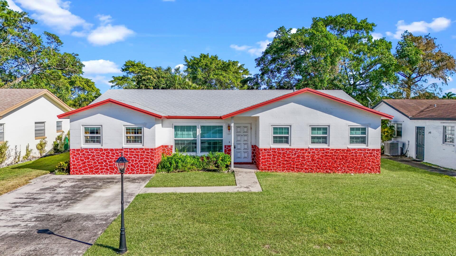 22602 Southwest 54th Way Boca Raton, FL 33433 - Photo 23 of 23 a front view of a house with a yard and garage