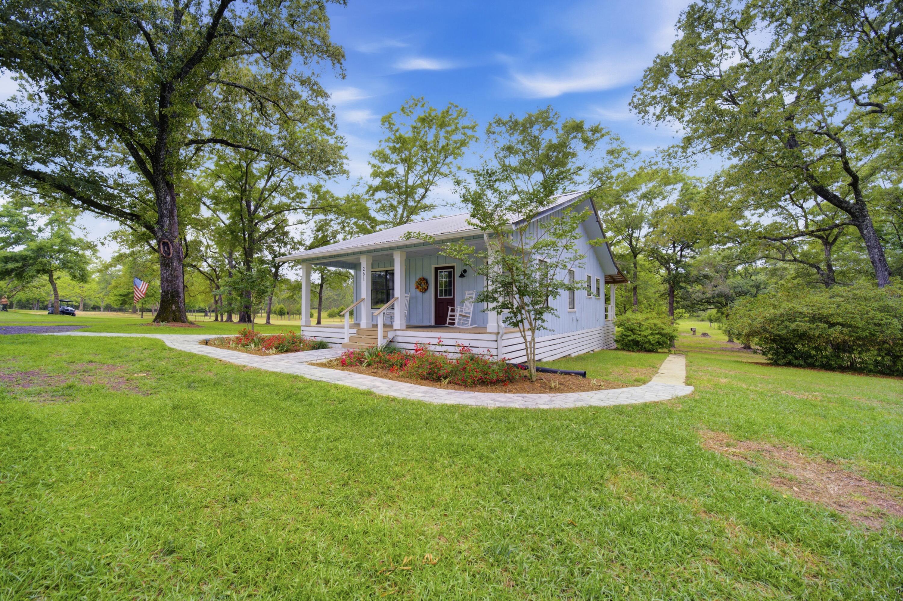 261 Wilkerson Road DeFuniak Springs, FL 32433 - Photo 46 of 76 a view of a house with swimming pool and garden