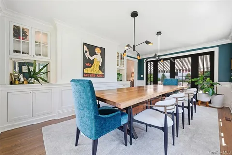 a dining room with furniture wooden floor a chandelier