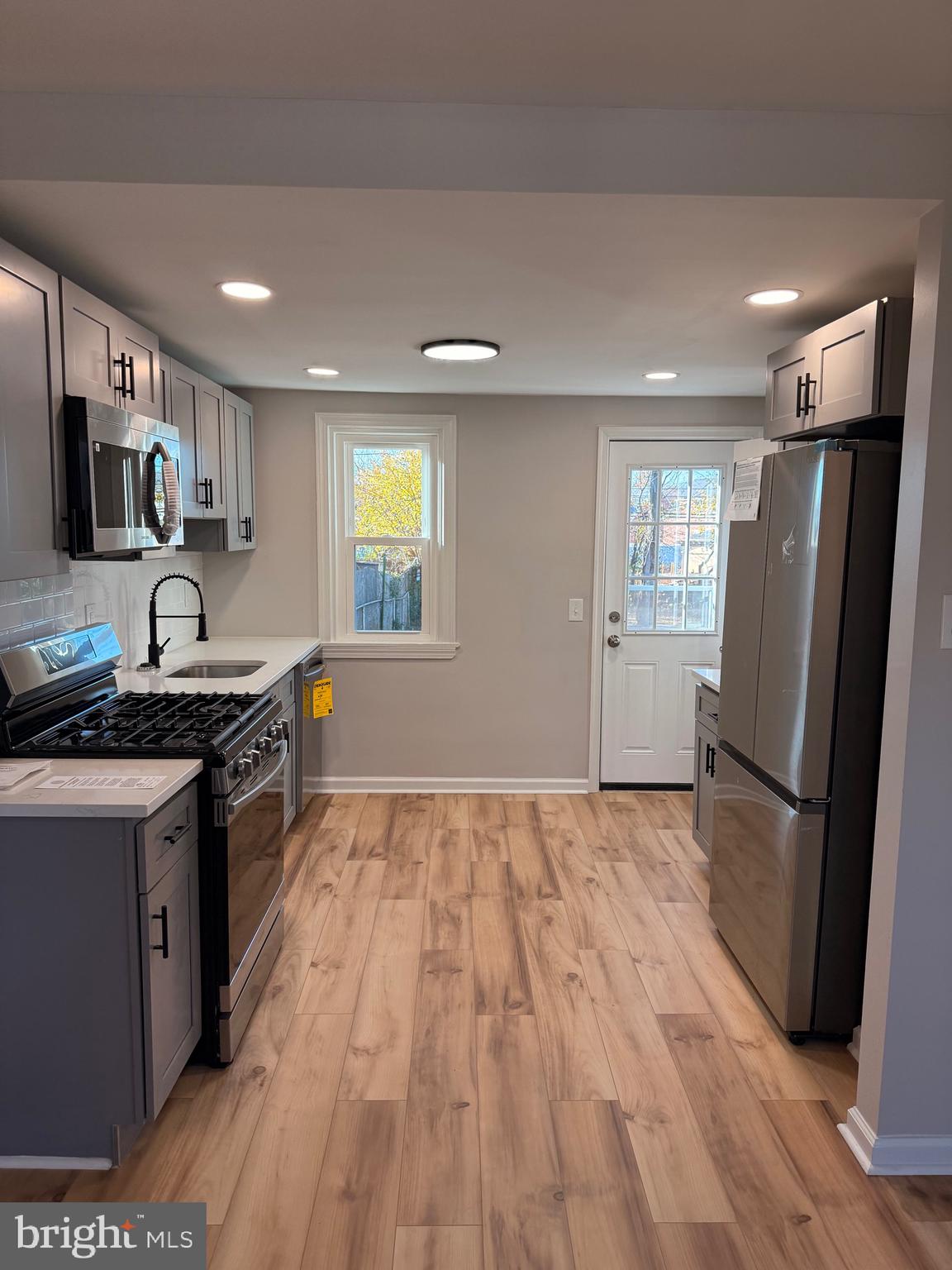 723 Parklane Road Swarthmore, PA 19081 - Photo 4 of 11 a kitchen with stainless steel appliances a refrigerator sink and stove